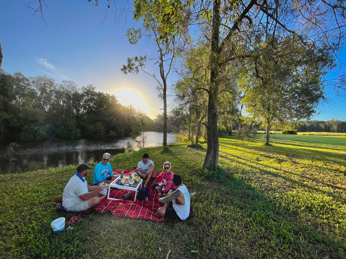 Picnic by the river at sunset