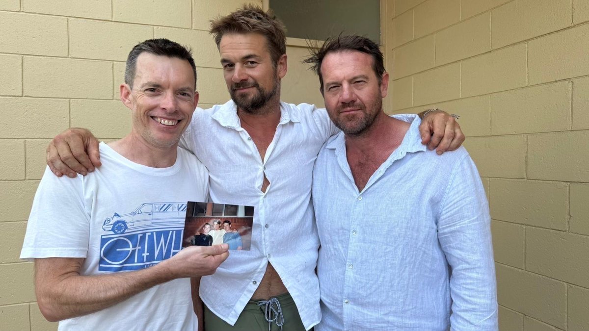 Jono, Pete and Dan now, holding the old teenage photo